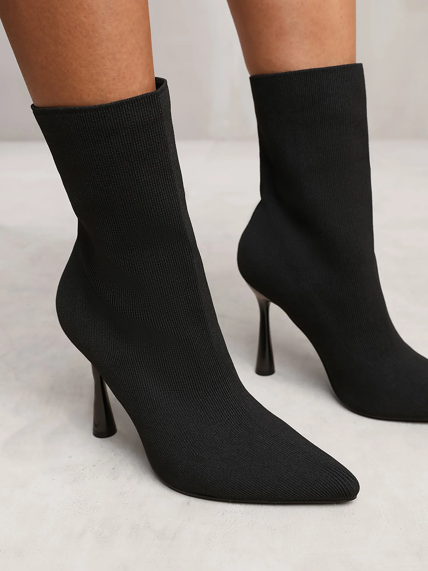 NELLOFER KNITTED HIGH HEEL ANKLE SOCK BOOTS WITH POINTED TOE IN BLACK